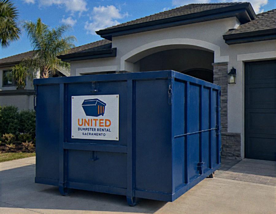 Navy blue roll-off dumpster delivered on a Sacramento driveway